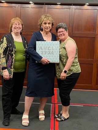 June Banquet Bernadette receives 2024 scrapbook from Jan and Josephine