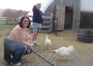 Tara Sottile with chickens. Her nephew is in the background